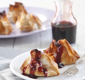 Dumplings filled with pumpkin and almonds in pomegranate sauce