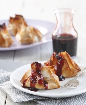 Dumplings filled with pumpkin and almonds in pomegranate sauce